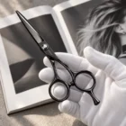 CHITIAN Z-01 black titanium scissors held in a gloved hand
