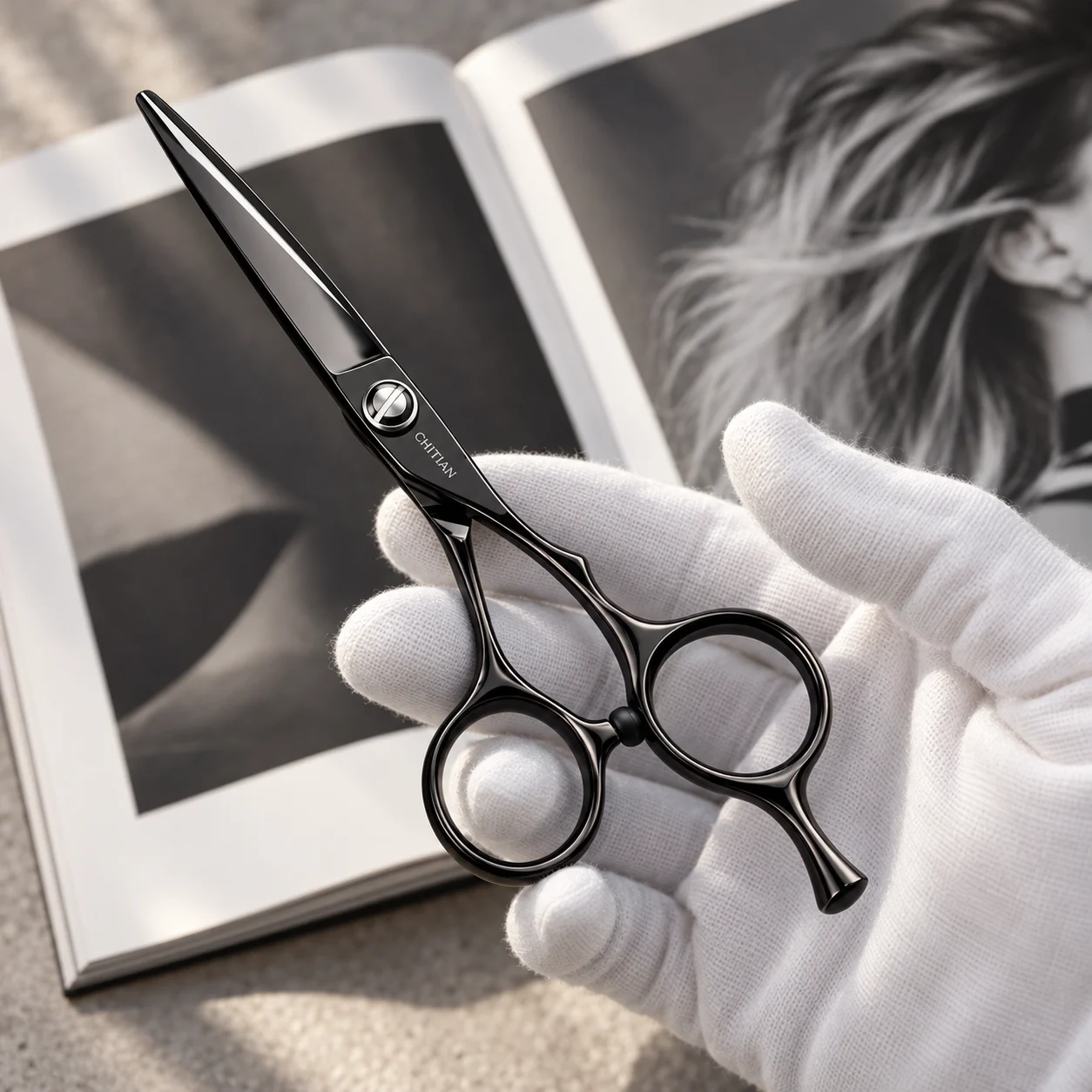 CHITIAN Z-01 black titanium scissors held in a gloved hand